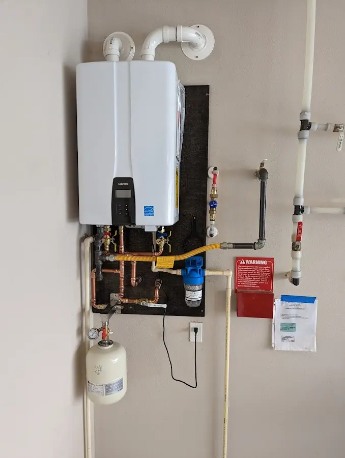 Professional plumber installing copper piping in a Charlotte home